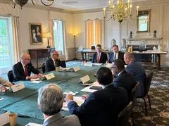 Group of people around a table having a discussion